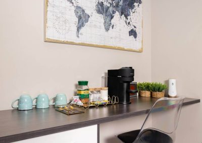 Coffee station with mugs, jars, and coffee machine in Menlyn Maine apartment