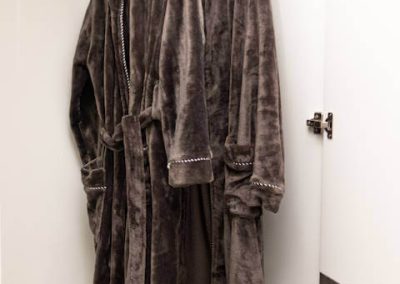 Two luxury bathrobes hanging in Menlyn Maine apartment wardrobe