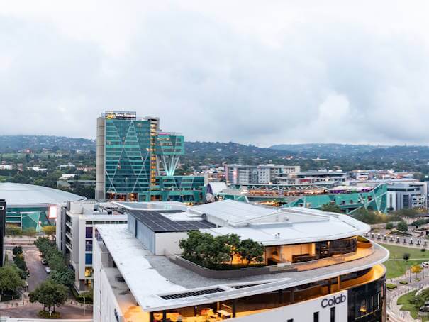 Scenic balcony view overlooking Menlyn Maine with modern buildings and cityscape in Pretoria.
