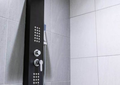 Menlyn Maine bathroom with luxury black shower panel and grey tile walls