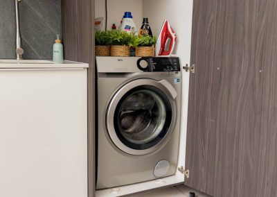 Washing machine with laundry supplies in Menlyn Maine apartment